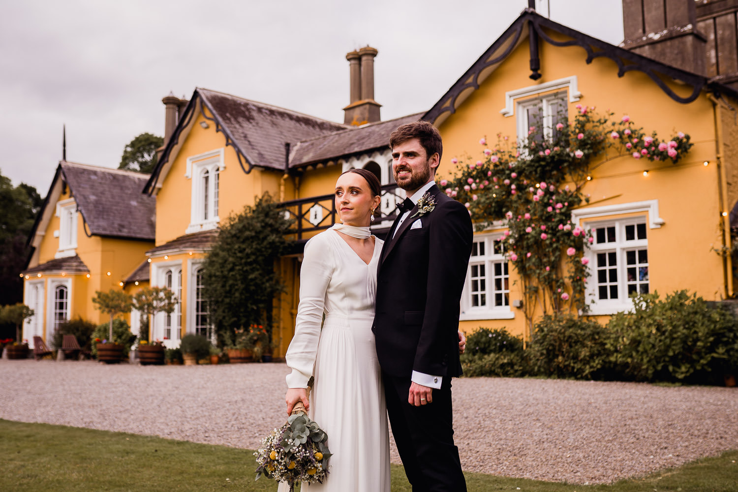 bride and groom standing in front of Martinstown House