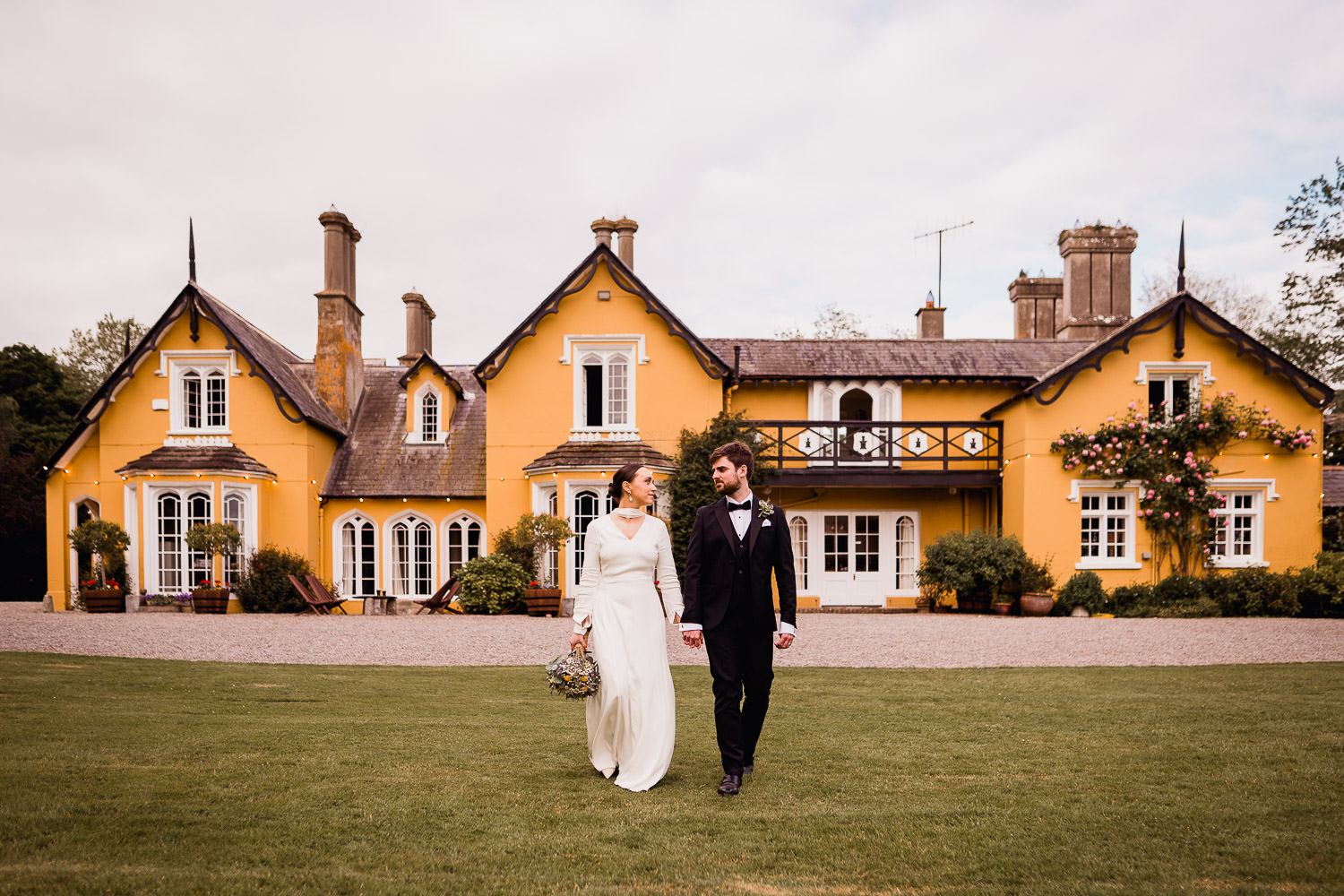 bride and groom holding hands at Martinstown House