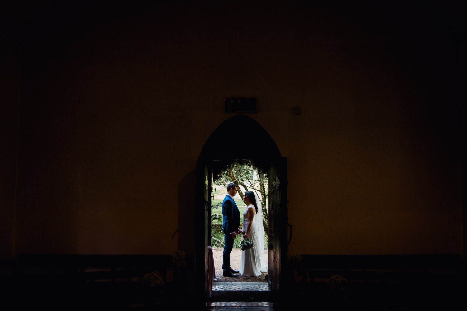 bride and groom standing in a doorway