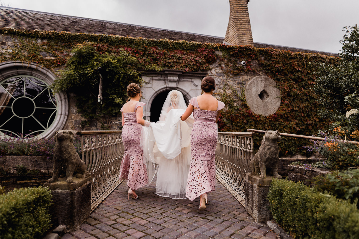 bridesmaids carrying the brides dress at Cliff at Lyons