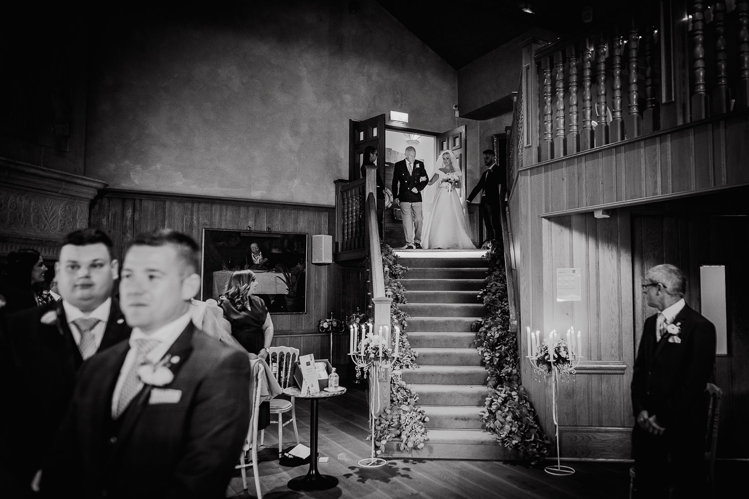 bride walking down the stairs with her father 