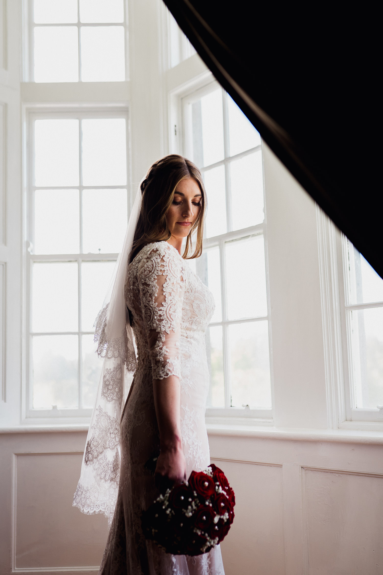 bride standing in window light at Kinnitty Castle