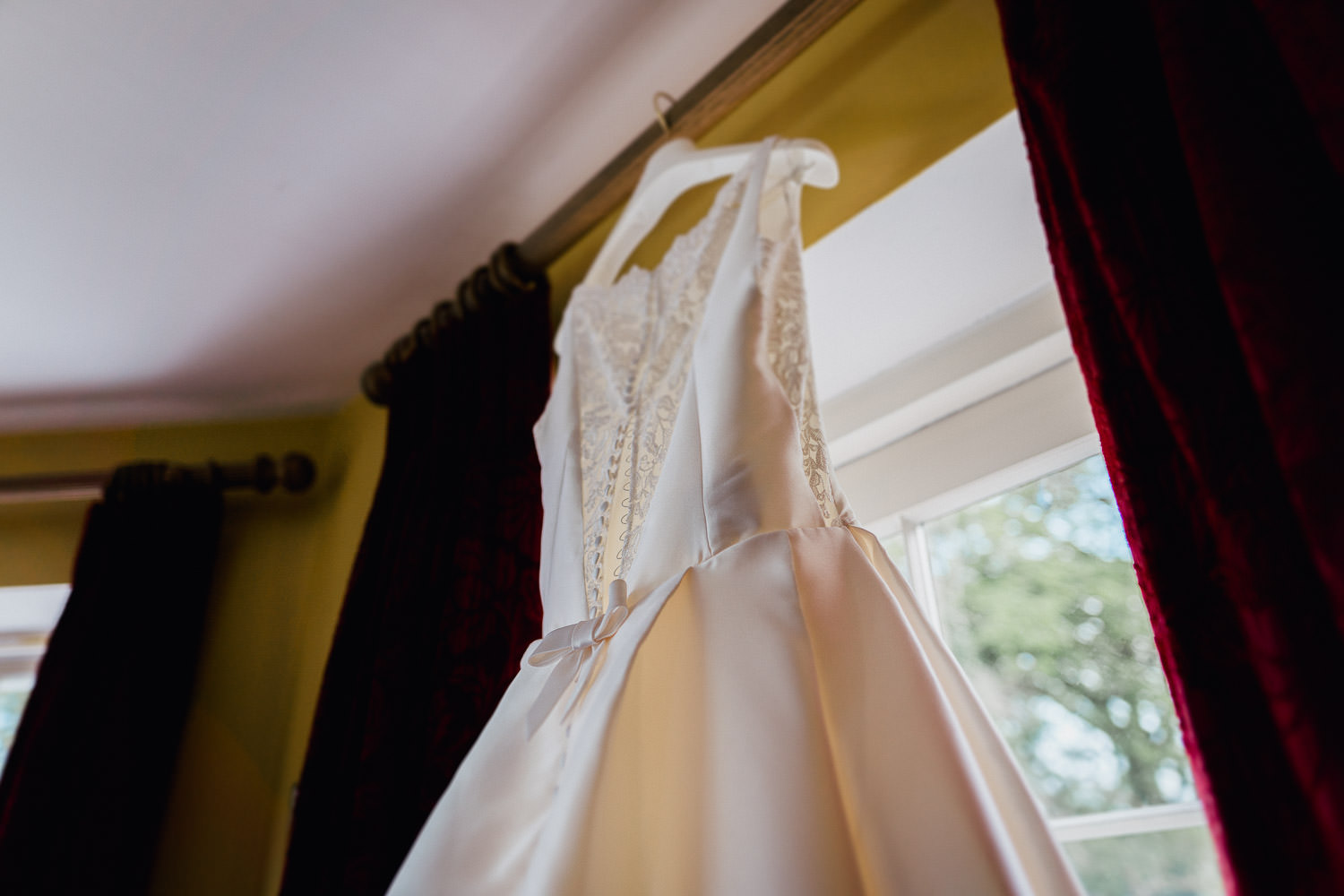 wedding dress hanging in a window