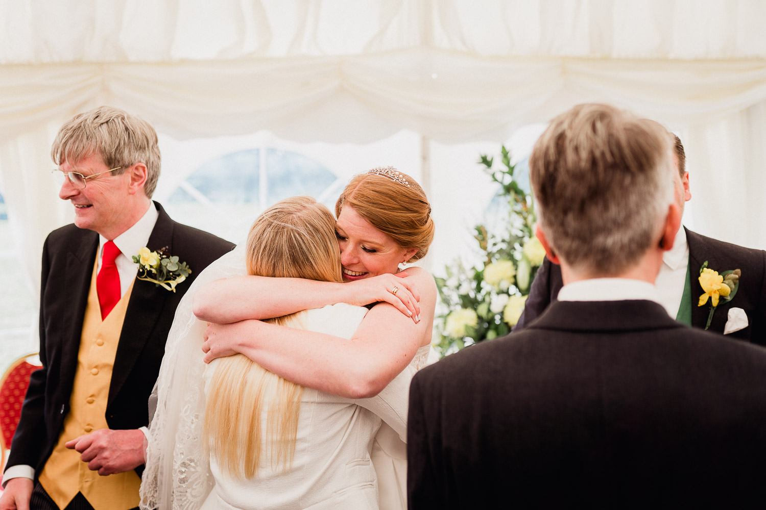 bride hugging wedding guests
