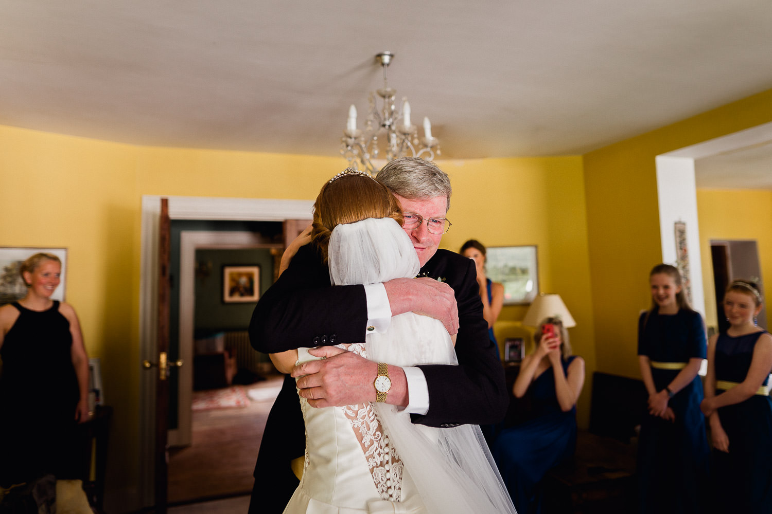 father of the bride hugging bride