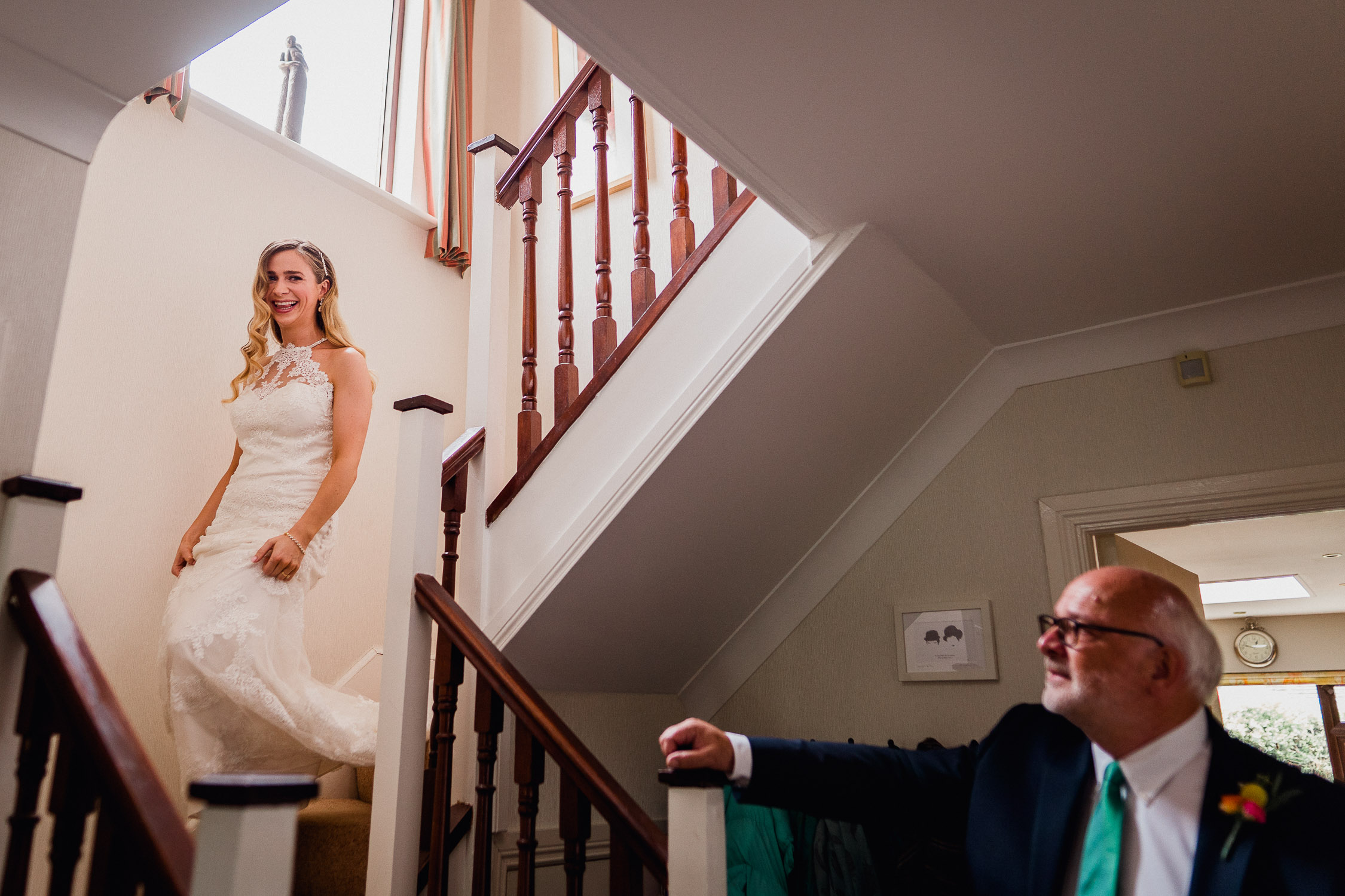 Bride walking down the stairs to meet her dad