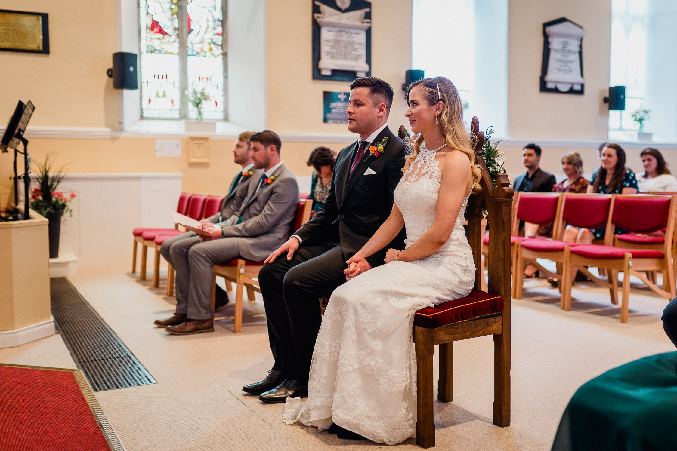 bride and groom sitting in the church during the ceremony