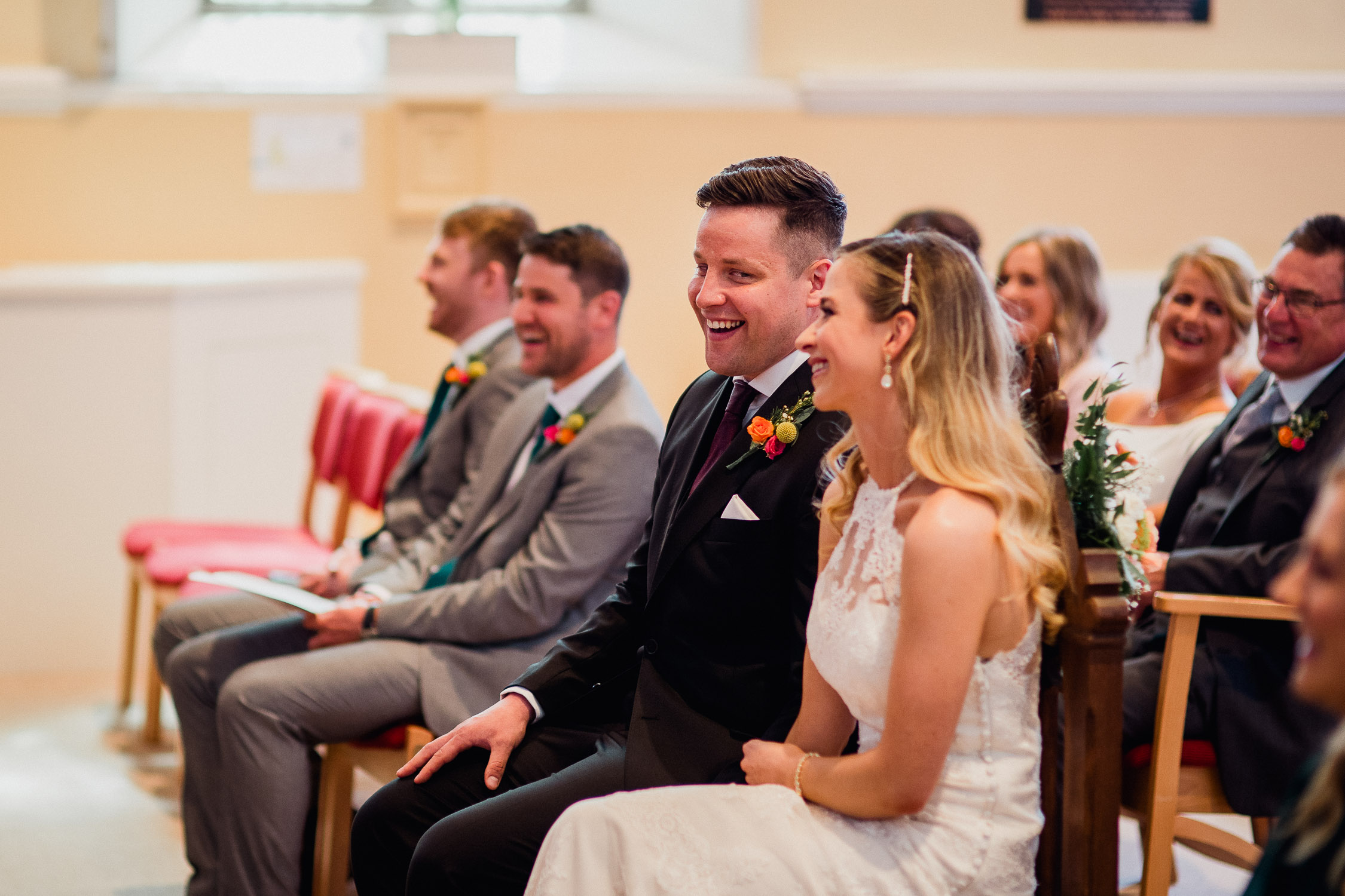 bride and groom laughing together during the ceremony