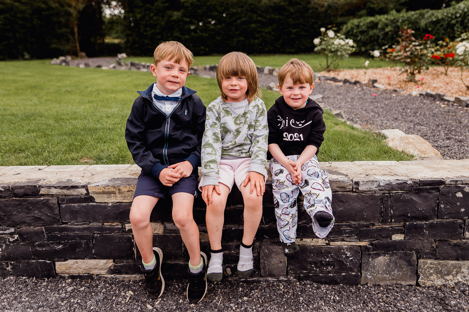 boys sitting on a wall