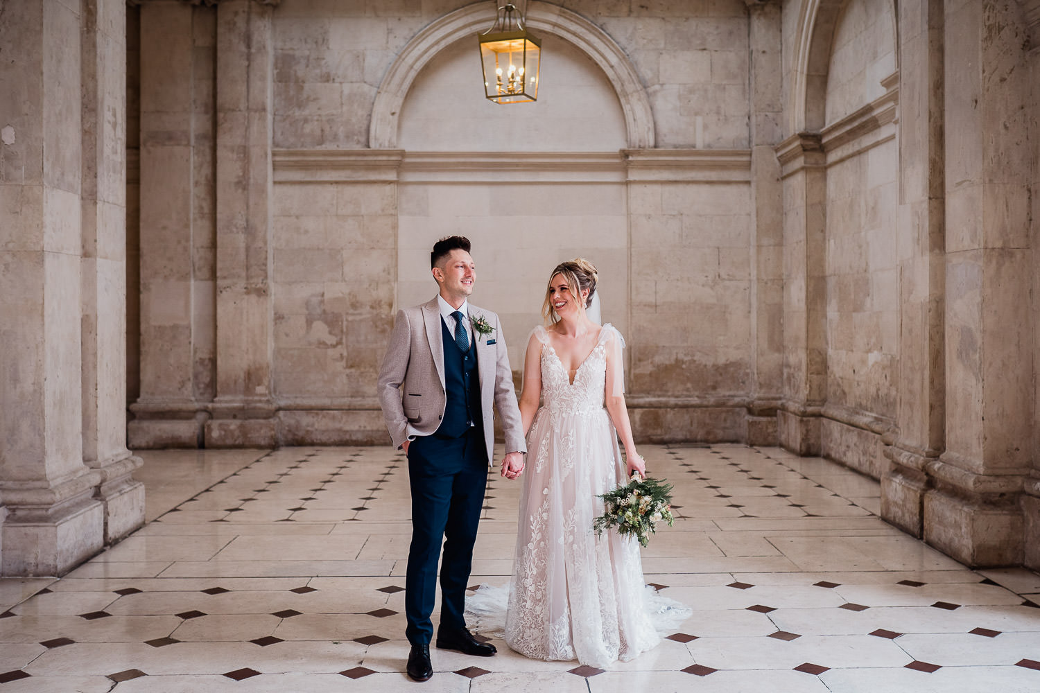 bride and groom holding hands at City Hall Dublin