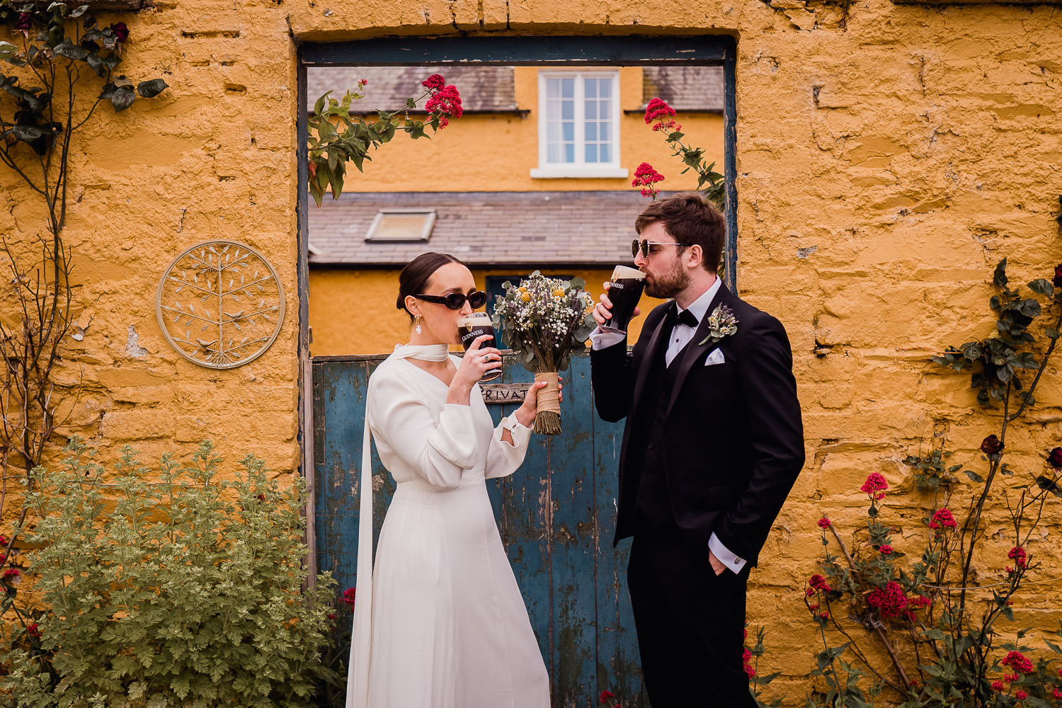 bride and groom drinking a pint of Guinness at Martinstown House