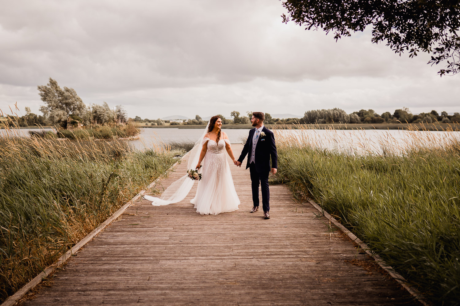 bride and groom holding hands at Ashley Park House
